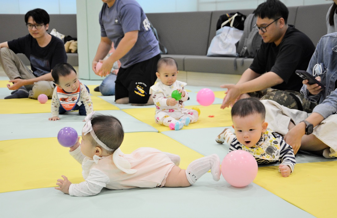 Babies crawl with excitement inside the “Baby Book Club.”